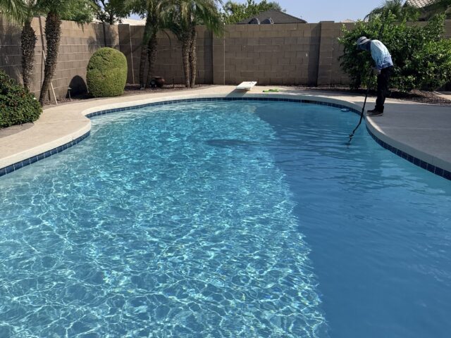 Pool technician performing weekly pool cleaning in Fortuna Foothills, Arizona