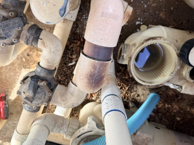 Disconnected pool equipment plumbing before piping repair in Yuma, Arizona